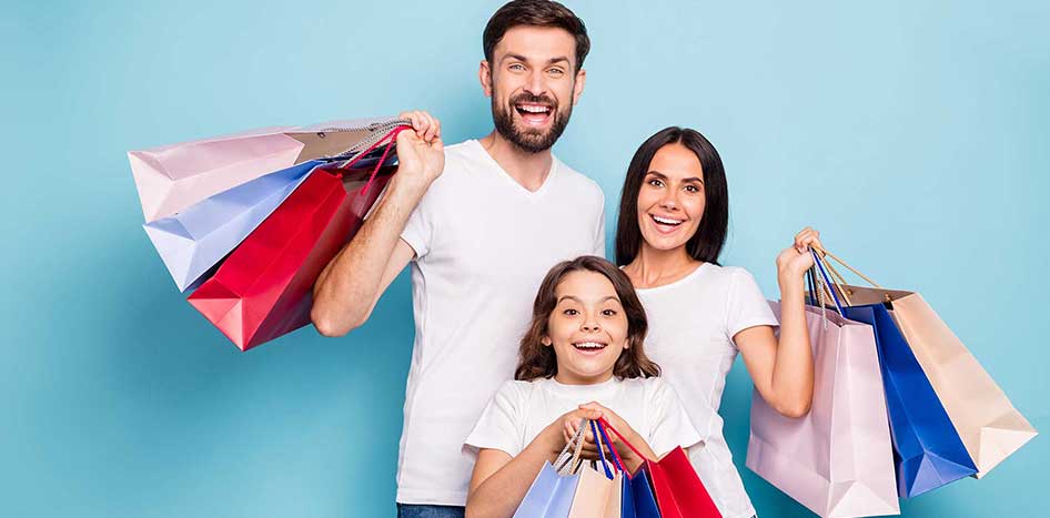 family-smiling-holding-shopping-bags